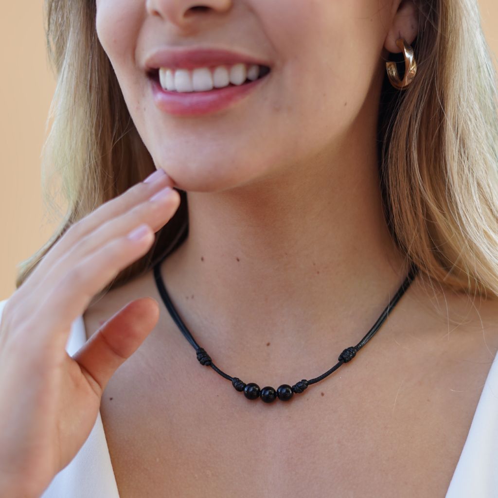 Female adorned with a Black Tourmaline Beaded Choker, highlighting how the dark, protective beads complement his modern and stylish look - Luck Strings