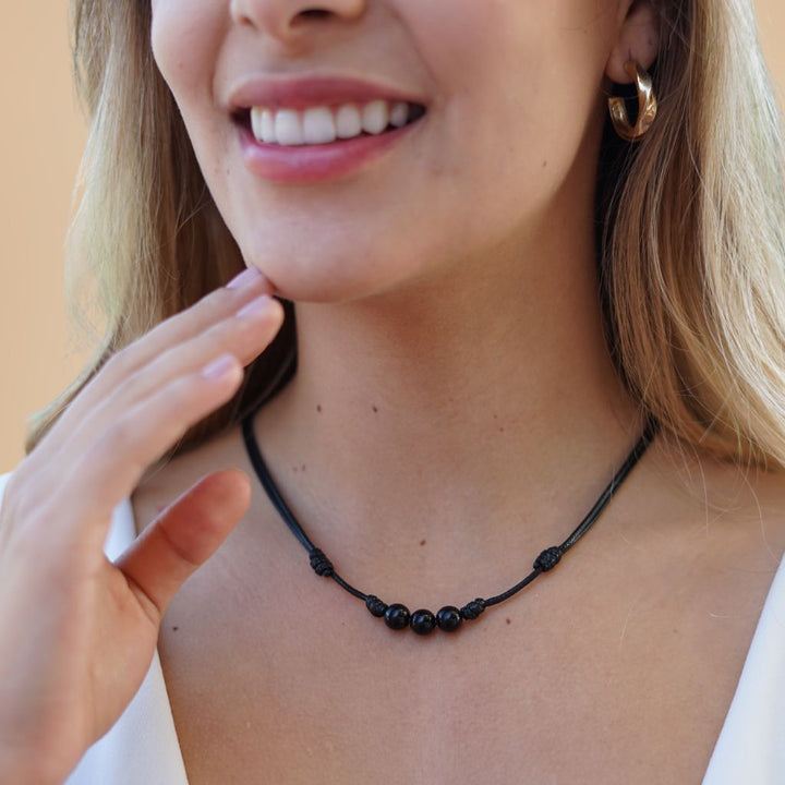 Female adorned with a Black Tourmaline Beaded Choker, highlighting how the dark, protective beads complement his modern and stylish look - Luck Strings