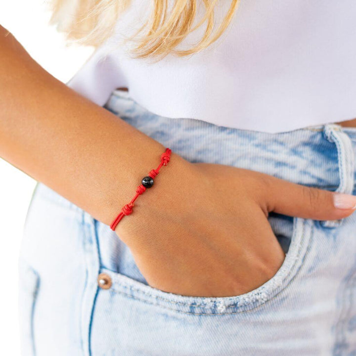 Woman displaying the Luck Strings Energy Shield Black Tourmaline Bracelet, a symbol of protection and fortune.