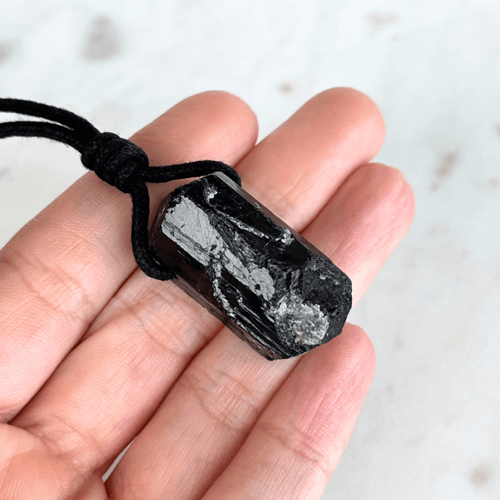 One-of-a-Kind Raw Black Tourmaline Pendant - A unique symbol of protection and individuality by Luck Strings.