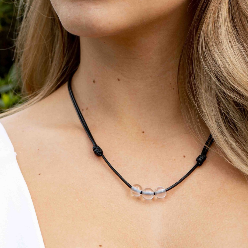 Woman gracefully wearing a Clear Quartz Beaded Choker, highlighting its luminous beads and adding a touch of refined elegance to her look - Luck Strings
