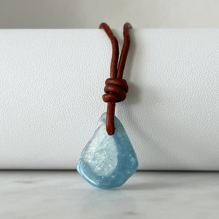 Unique one-of-a-kind raw aquamarine pendant with natural ocean-blue hues, showcasing the gemstone's unpolished beauty on a delicate cord - Luck Strings.