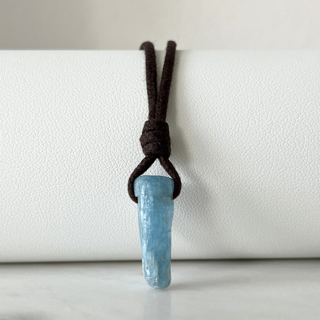 Unique Raw Aquamarine Stick Pendant, showcasing its elongated, natural form and serene blue hues, symbolizing tranquility and clarity - Luck Strings.