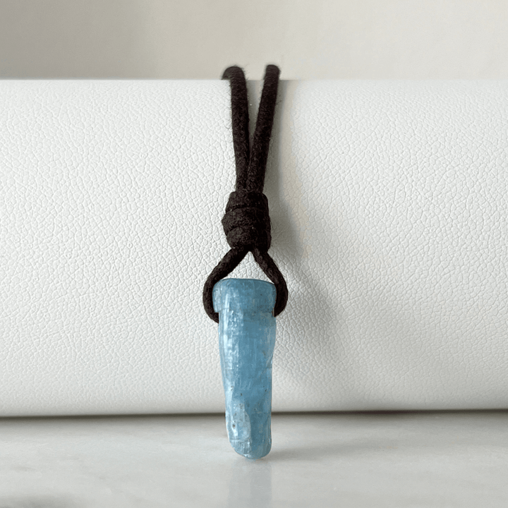 Unique Raw Aquamarine Stick Pendant, showcasing its elongated, natural form and serene blue hues, symbolizing tranquility and clarity - Luck Strings.