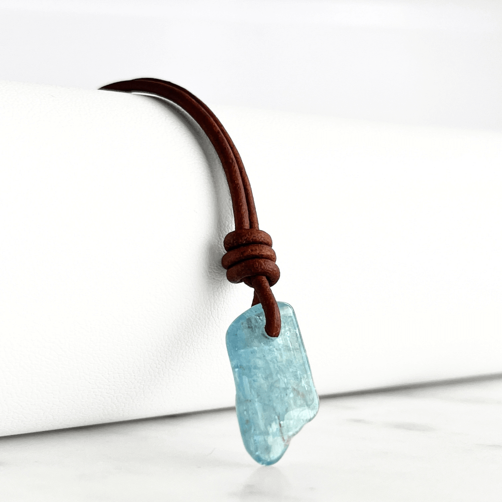 Serene Reflections: A pendant necklace showcasing a natural small aquamarine gemstone, echoing the calm and peaceful reflections of a tranquil surface.