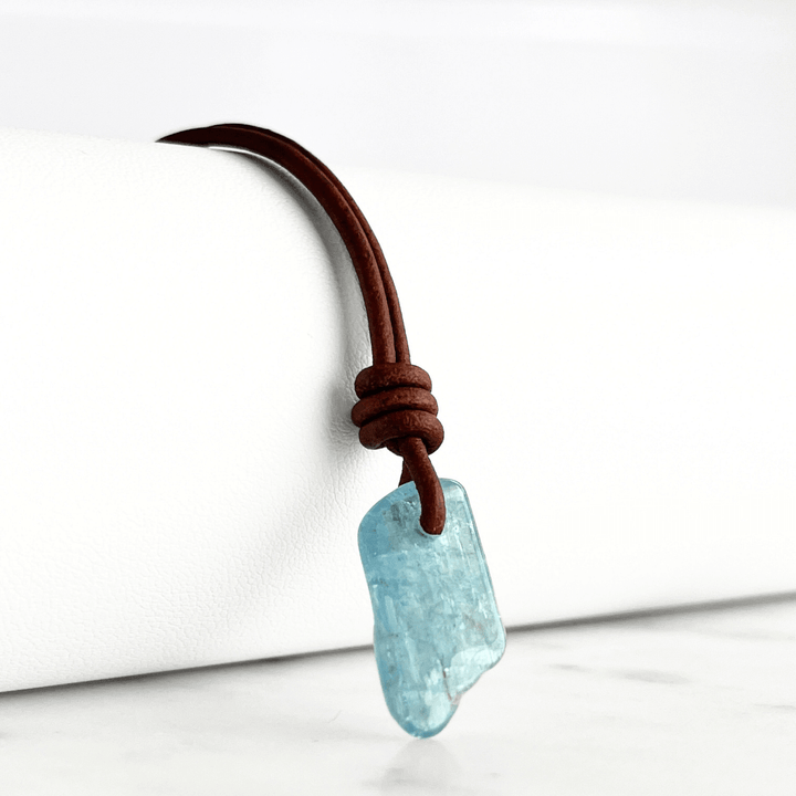 Serene Reflections: A pendant necklace showcasing a natural small aquamarine gemstone, echoing the calm and peaceful reflections of a tranquil surface.