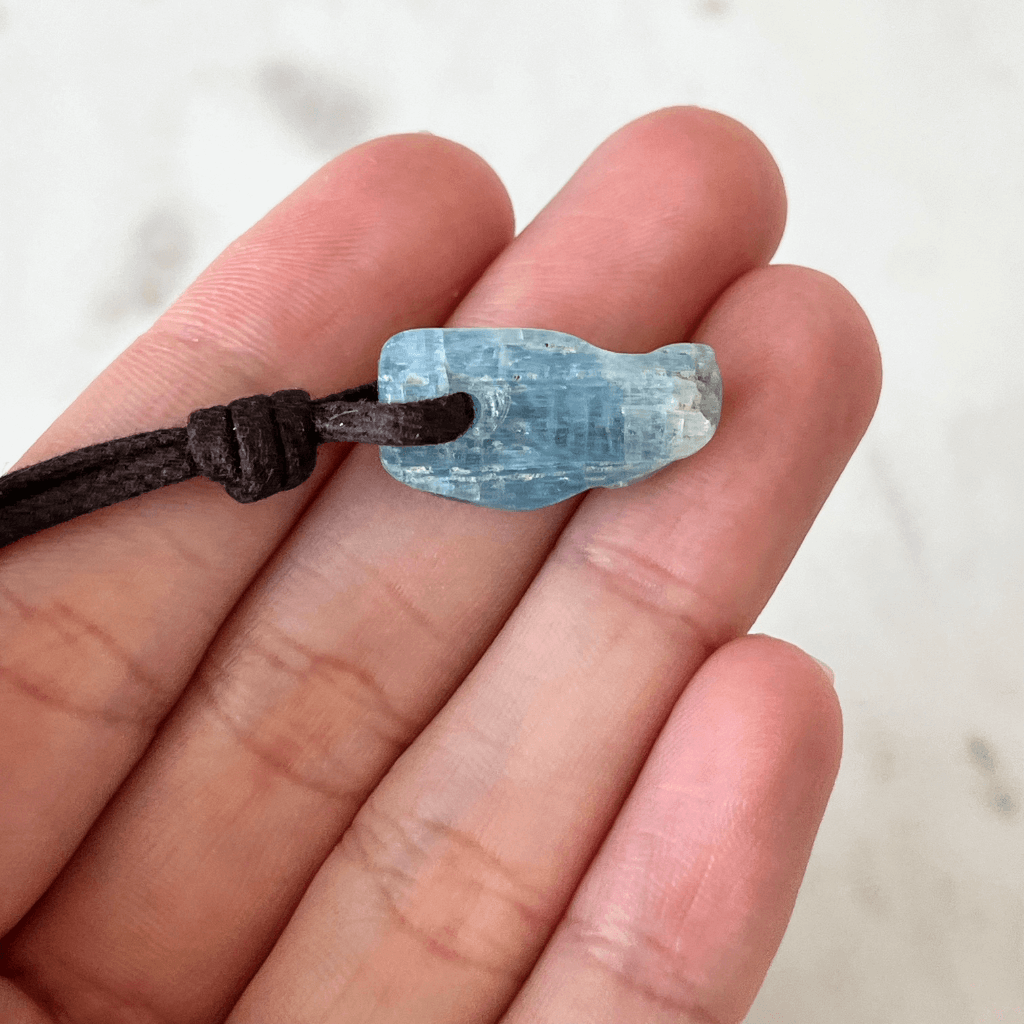 Unique Raw Aquamarine Stick Pendant, showcasing its elongated, natural form and serene blue hues, symbolizing tranquility and clarity - Luck Strings.