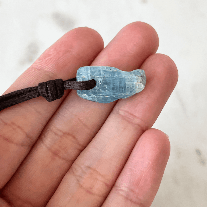 Unique Raw Aquamarine Stick Pendant, showcasing its elongated, natural form and serene blue hues, symbolizing tranquility and clarity - Luck Strings.
