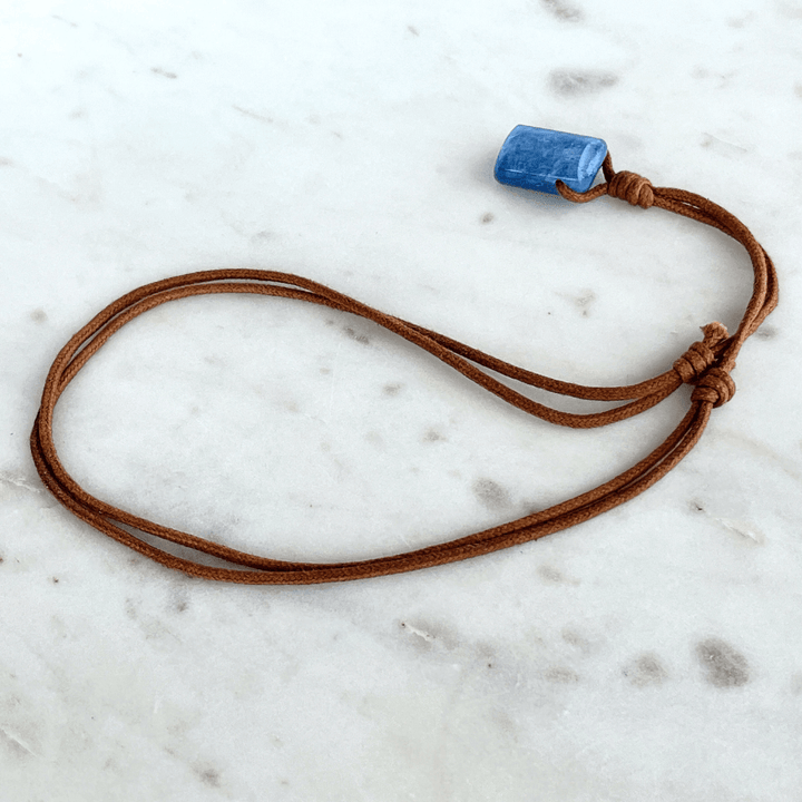 A unique handcrafted Kyanite pendant showcasing tranquil blue shades, embodying beauty and serenity.