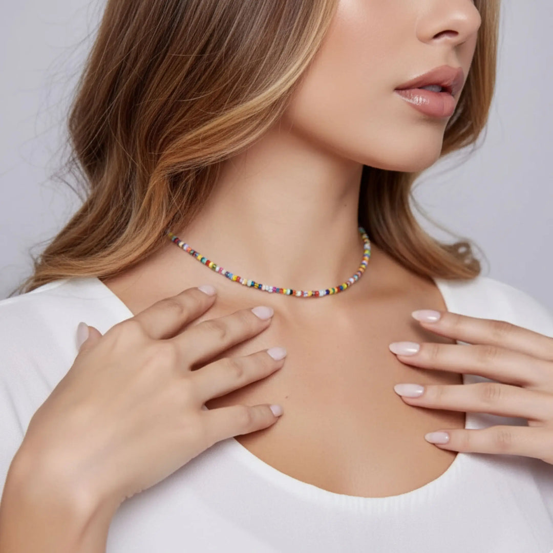 Woman wearing a colorful beaded necklace with a plain background