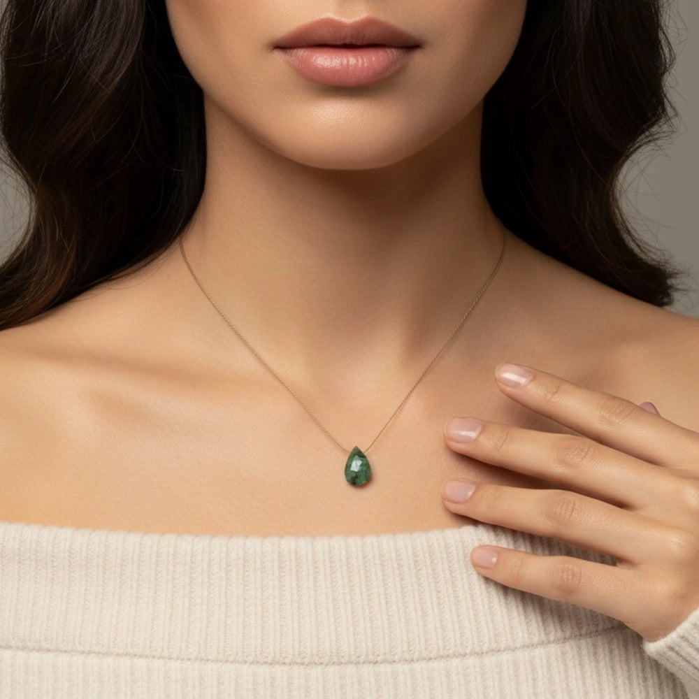 Emerald pendant necklace on women's neck