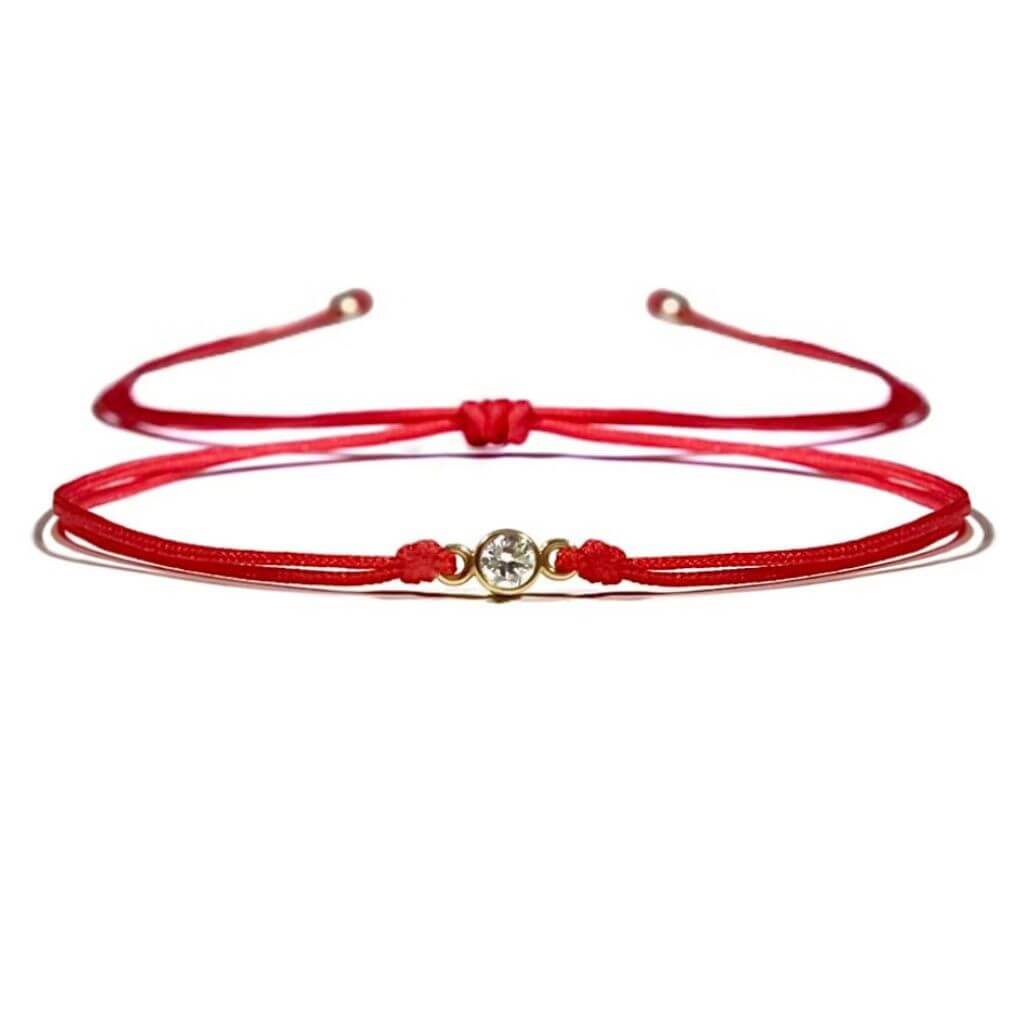 Close-up of a 14K Gold Diamond Bezel Red String Bracelet, featuring a 3mm 1/10 CT natural diamond and vibrant red string, symbolizing luck and protection with adjustable macrame knots – Luck Strings.