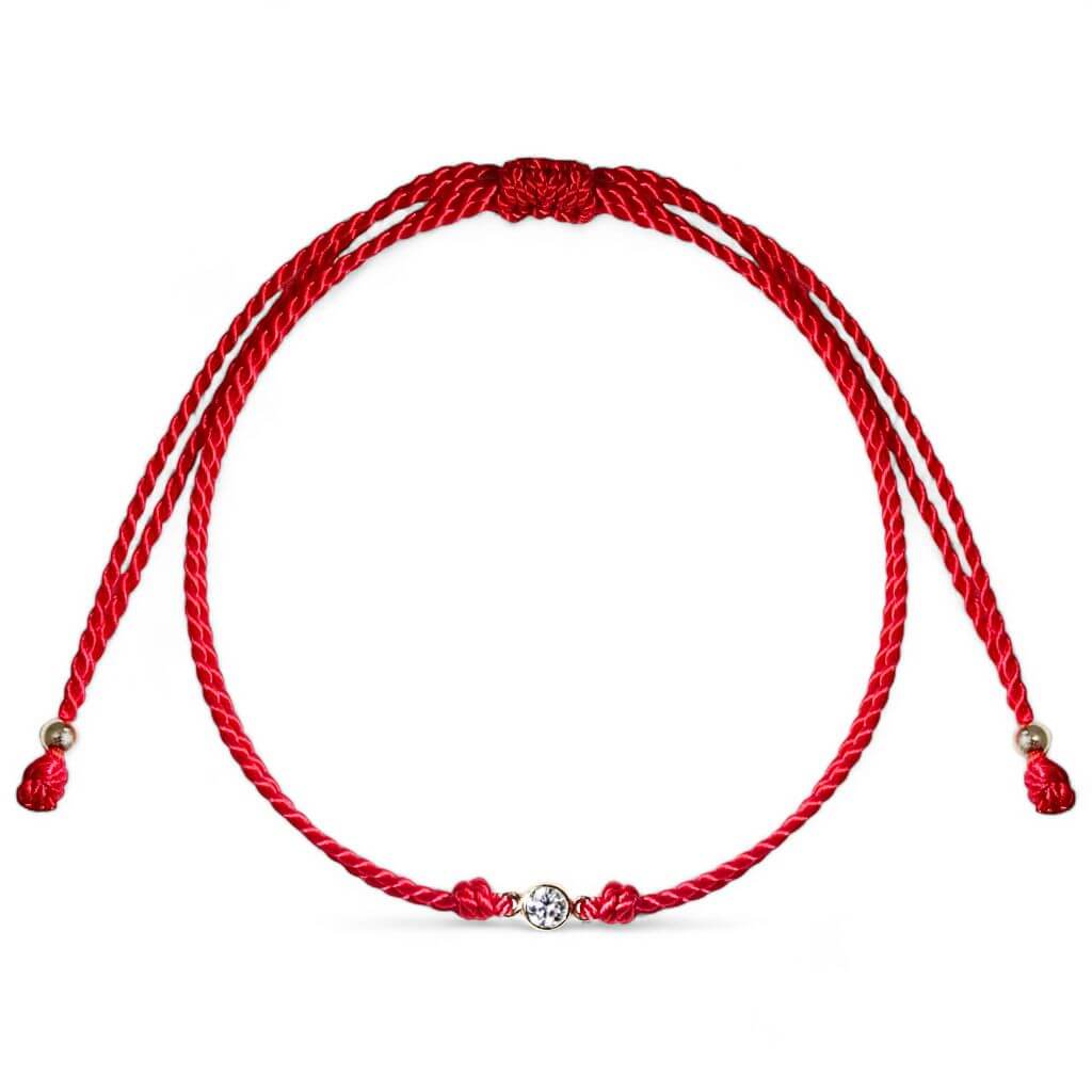 Close-up of a 14K Gold Diamond Bezel Red String Bracelet, featuring a 3mm 1/10 CT natural diamond and vibrant red string, symbolizing luck and protection with adjustable macrame knots – Luck Strings.
