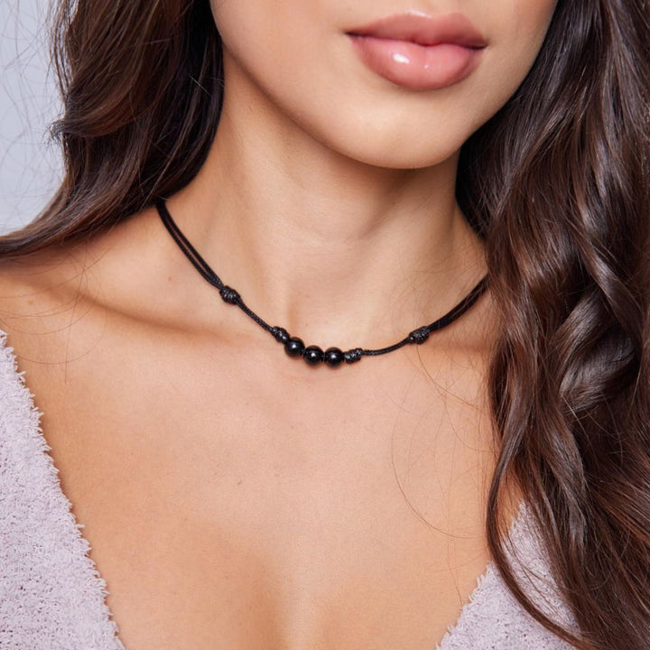 Female adorned with a Black Tourmaline Beaded Choker, highlighting how the dark, protective beads complement his modern and stylish look - Luck Strings