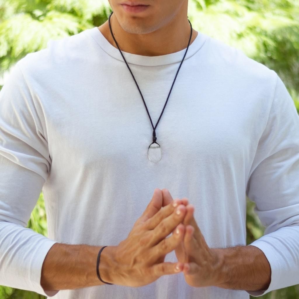 Luck Strings Clear Quartz pendant necklace elegantly displayed by a man in a casual shirt, with the stone prominently featured against his chest