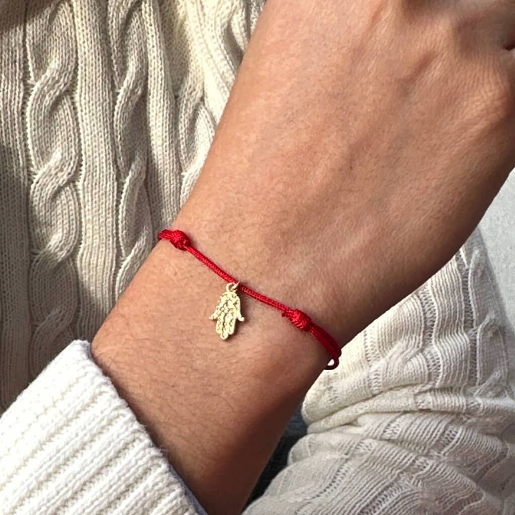 Adjustable gold vermeil Hamsa bracelet symbolizing protection and luck. Luck Strings