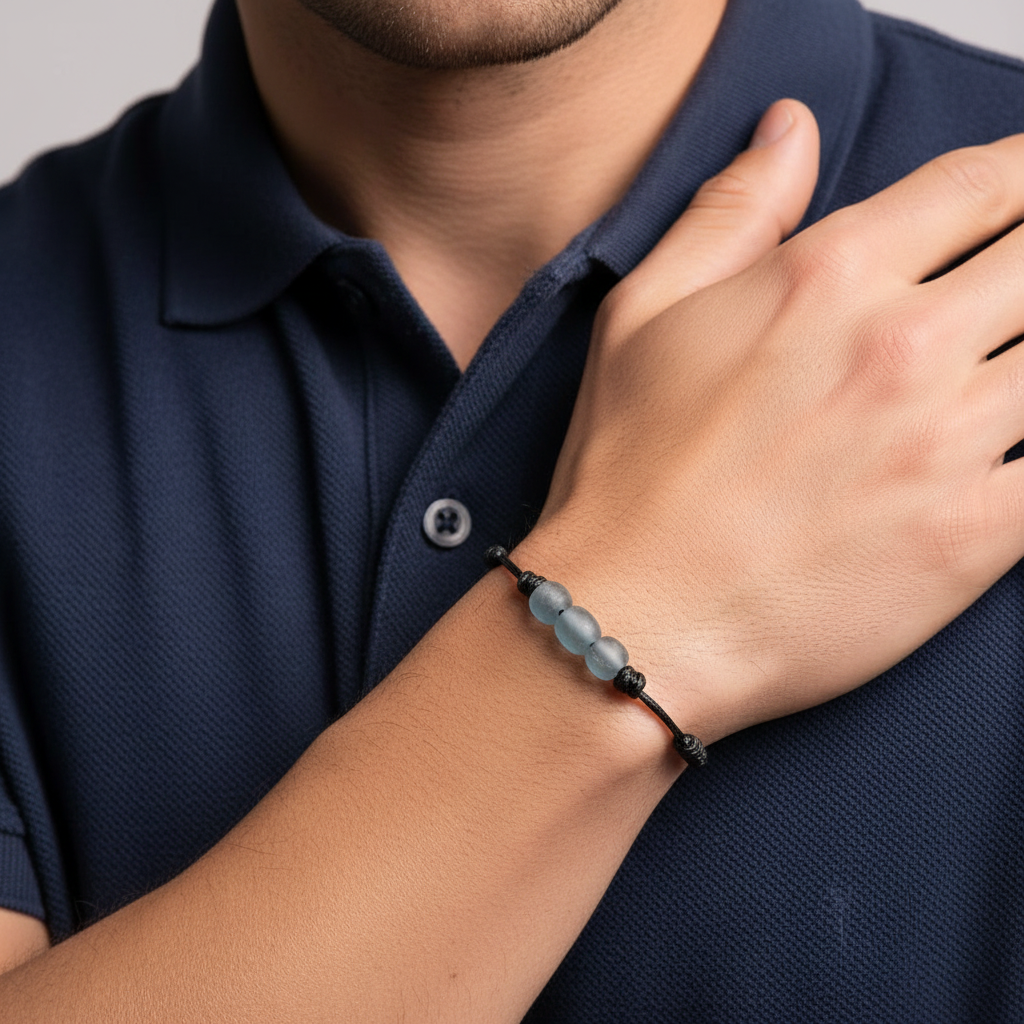 Person wearing a bracelet on a plain background