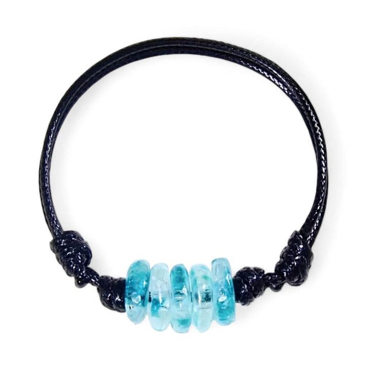 An ocean blue bracelet, made of recycled glass beads and a black cord.