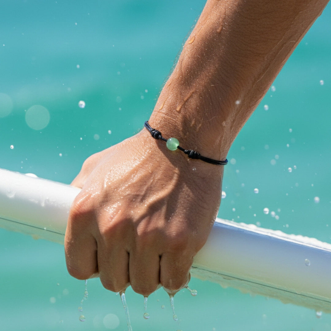 Men wearing green aventurine bracelet with black wax nylon cord worn on the wrist.