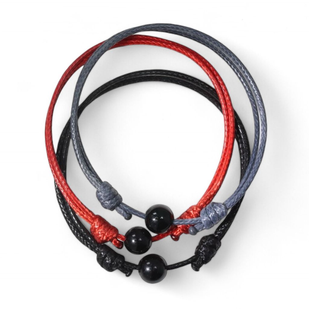 Adjustable black tourmaline bead bracelet with red and gray cord variants.