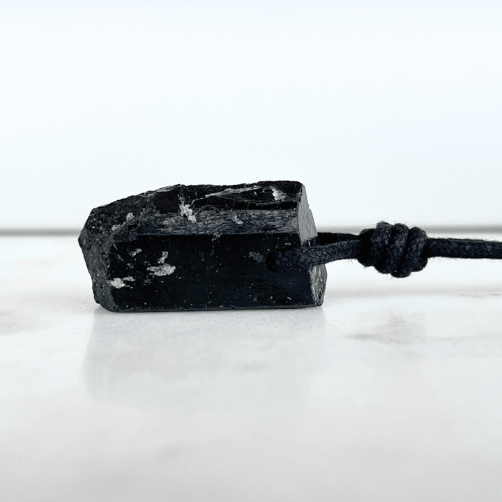 One-of-a-Kind Raw Black Tourmaline Pendant - A unique symbol of protection and individuality by Luck Strings.