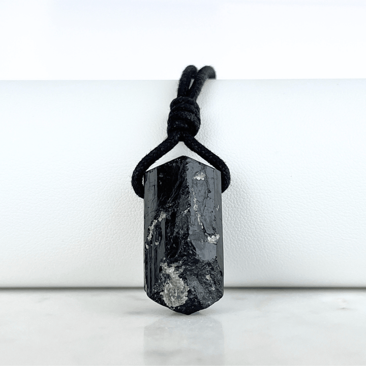 One-of-a-Kind Raw Black Tourmaline Pendant - A unique symbol of protection and individuality by Luck Strings.