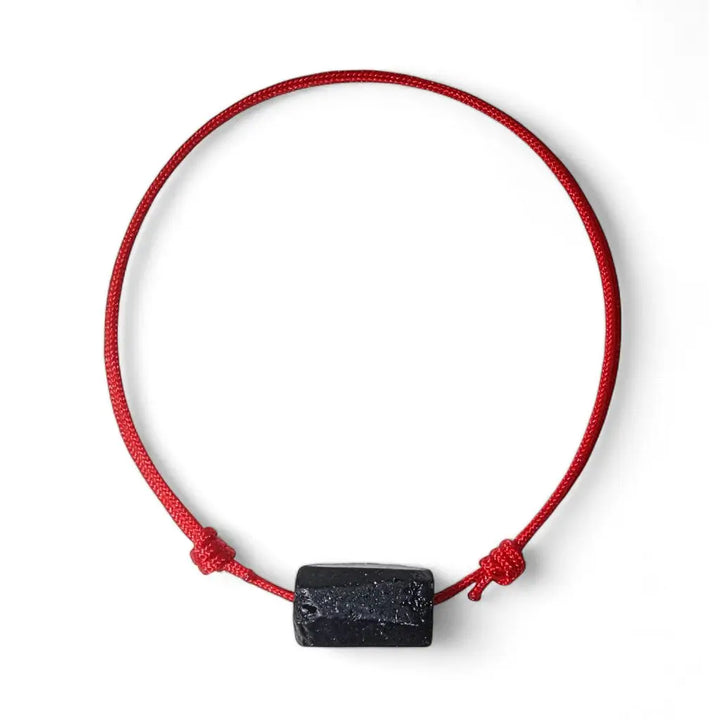 Adjustable red bracelet with a black tourmaline centerpiece and red string.
