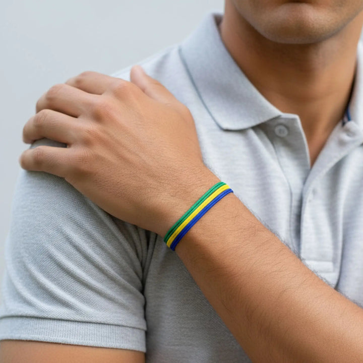 Person wearing a colorful bracelet on a plain background