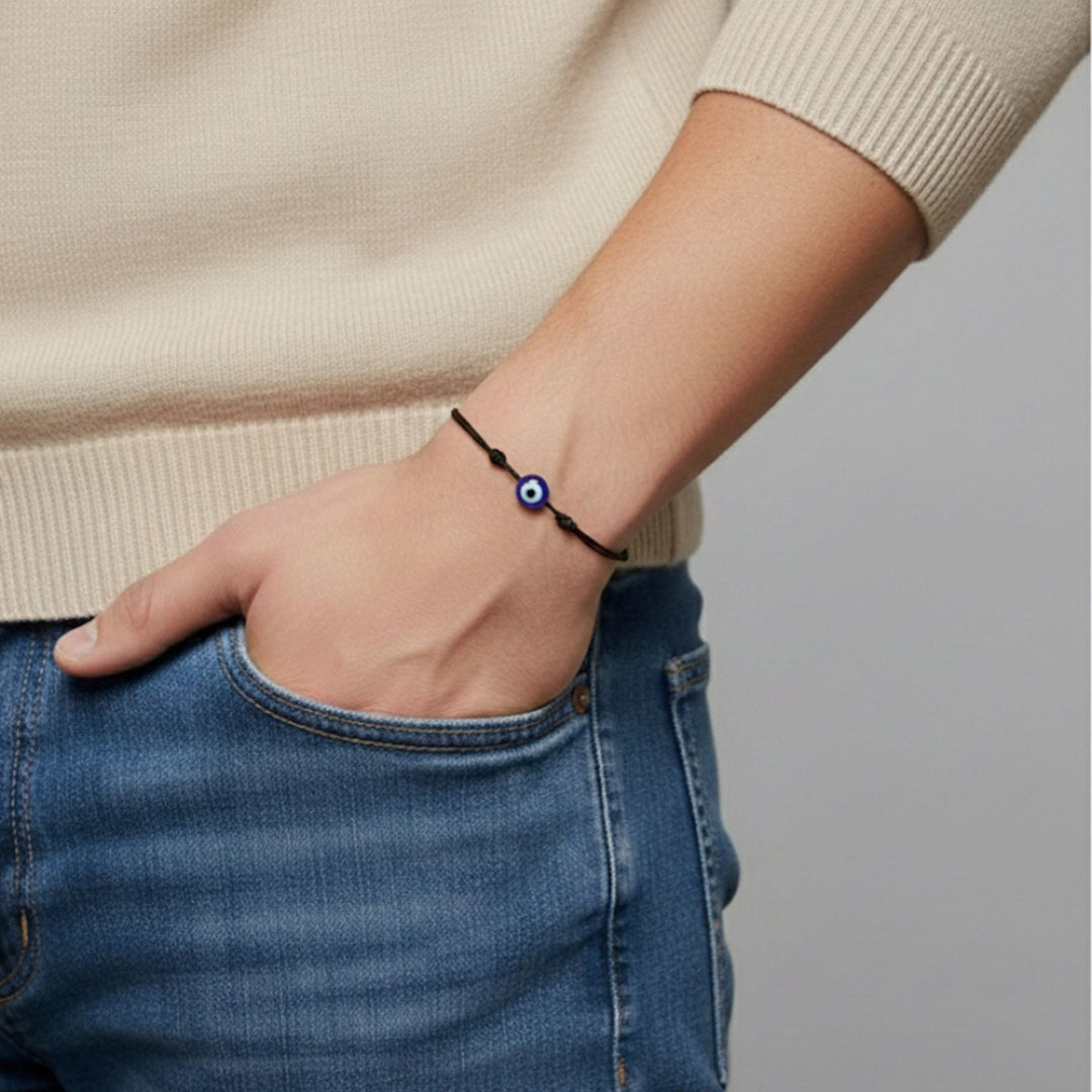 Person wearing a bracelet on a plain background