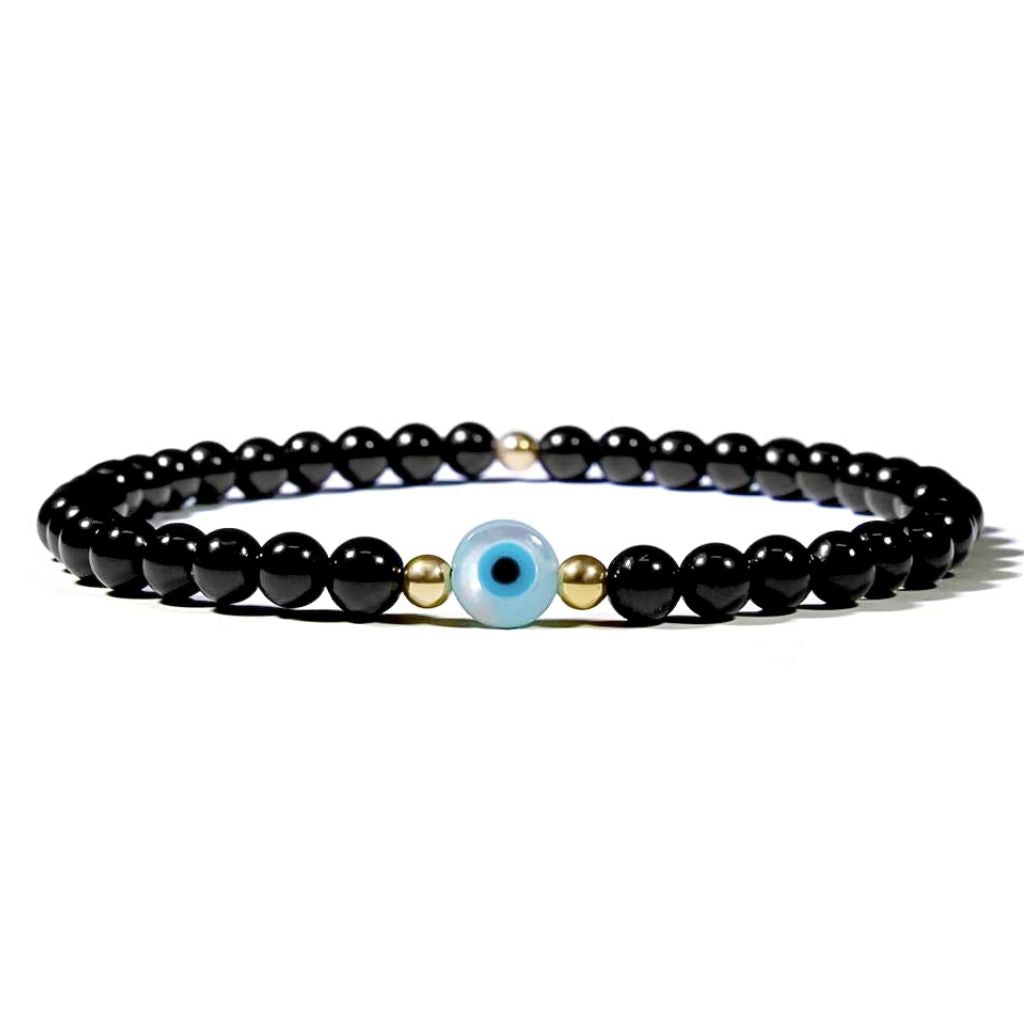 A black tourmaline and gold beaded bracelet with a mother of pearl evil eye charm.