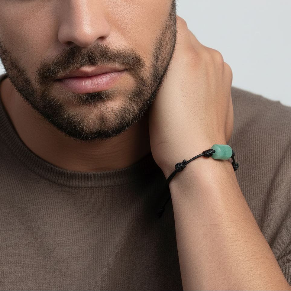 Man wearing green aventurine bracelet on black waxed cord, casual lifestyle view.
