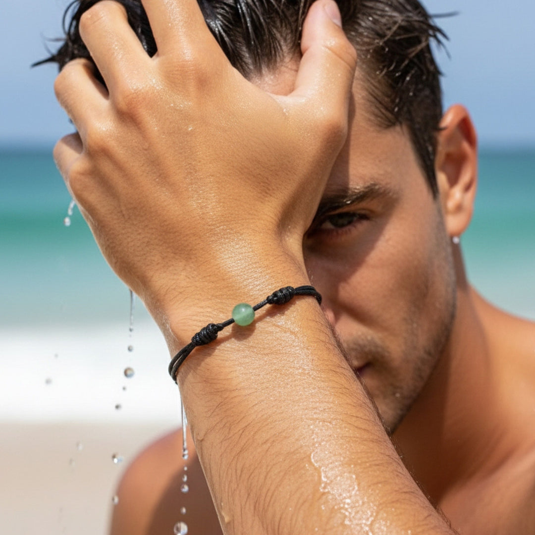 Man wearing green aventurine single bead bracelet on black waxed nylon cord.