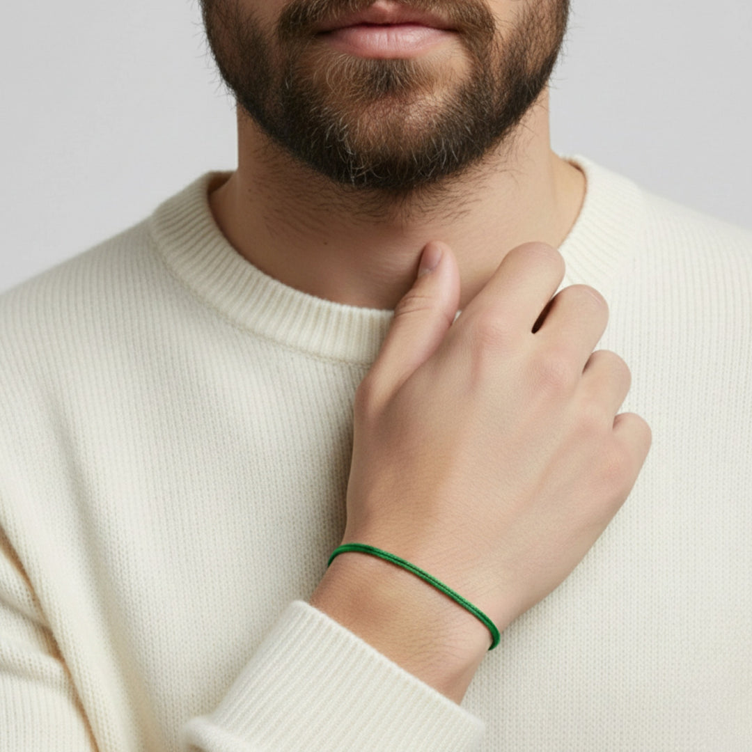 Person wearing a green waxed nylon cord bracelet on wrist with a white knit sweater