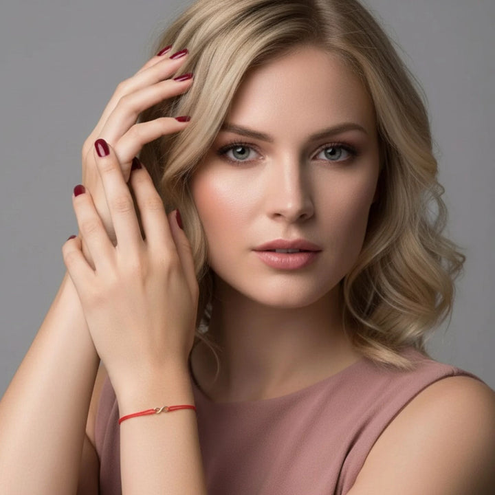 Woman with blonde hair and a pink top against a gray background