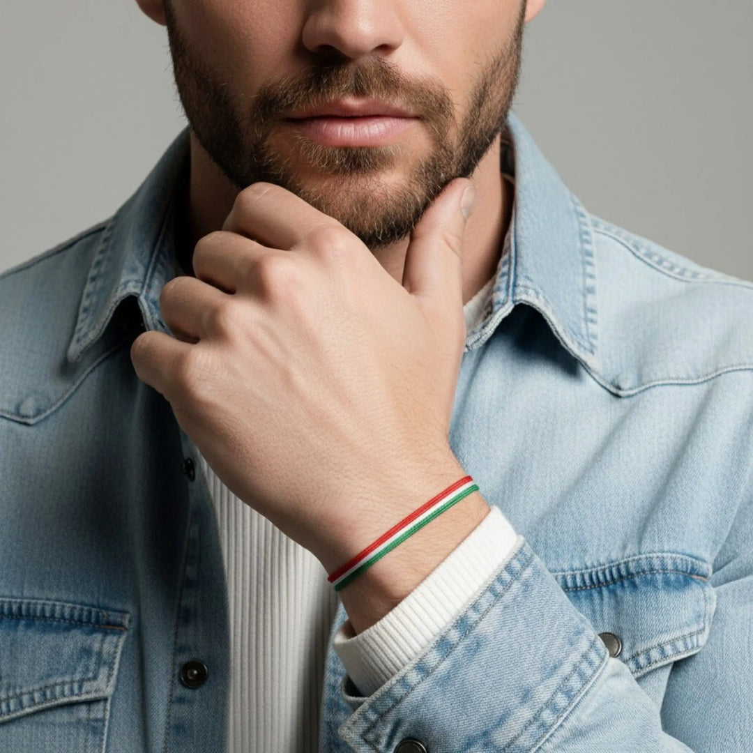 Man wearing a denim jacket with a colorful bracelet on his wrist.