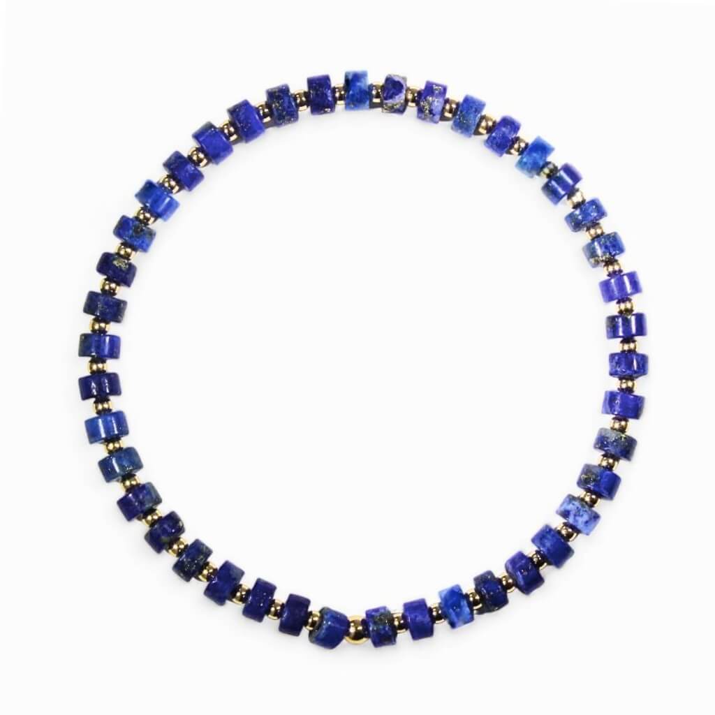 A circular lapis lazuli and 14K gold bracelet with gold accents and beads.