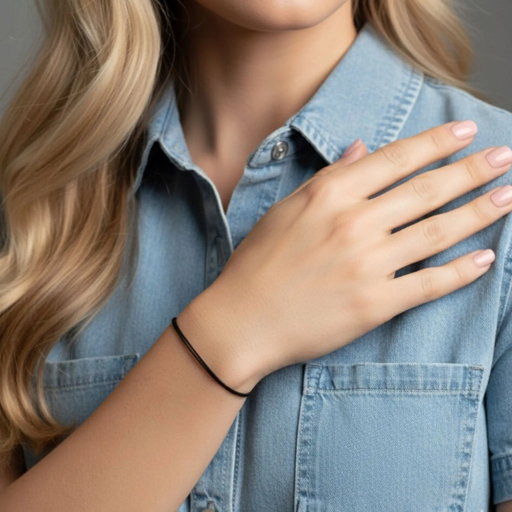 Person wearing a blue denim shirt with a hand on the chest