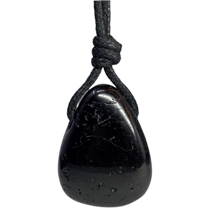 A black tourmaline pendant attached to a black cord, viewed from above the pendant.
