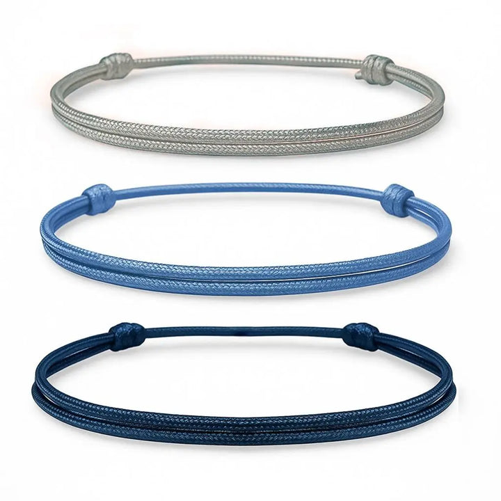 Three braided bracelets in gray, blue, and navy on a white background