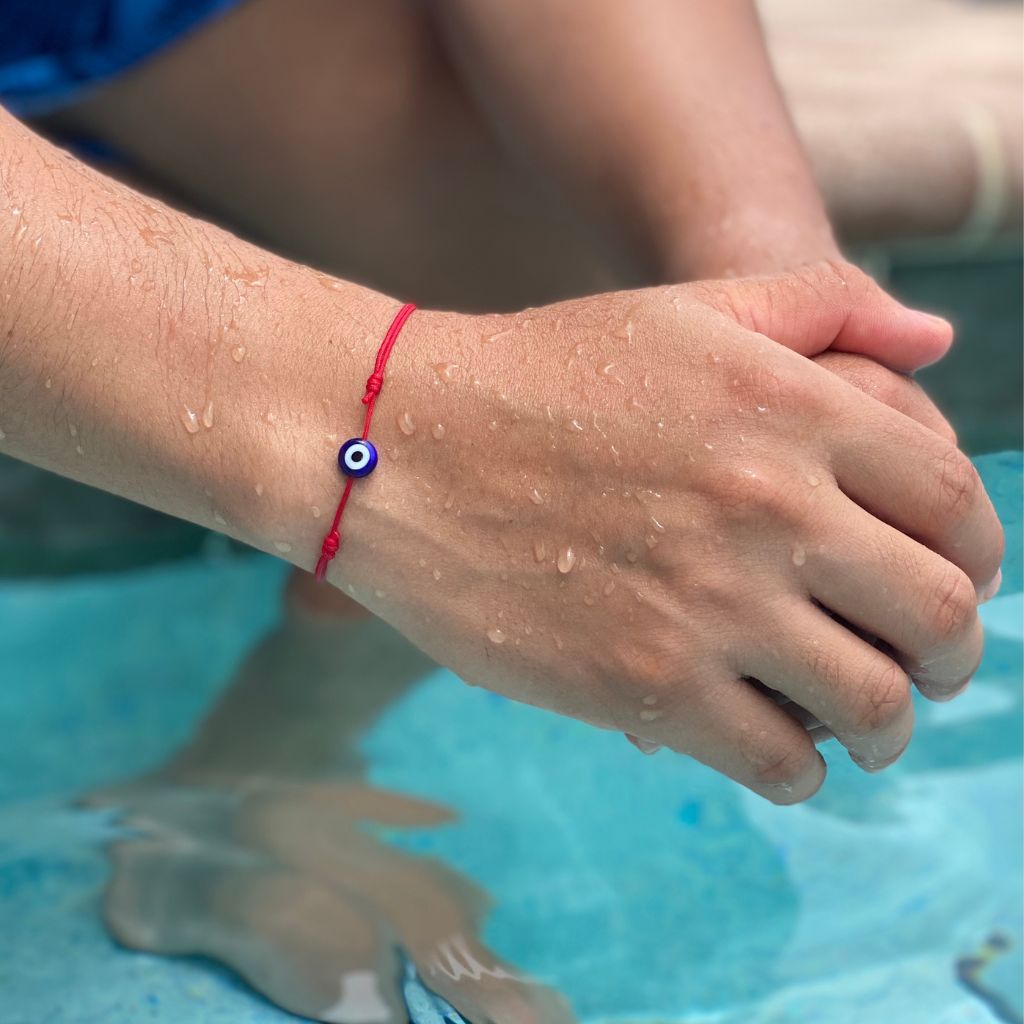 Waterproof red string bracelet with an evil eye charm, ideal for summer - Luck Strings.