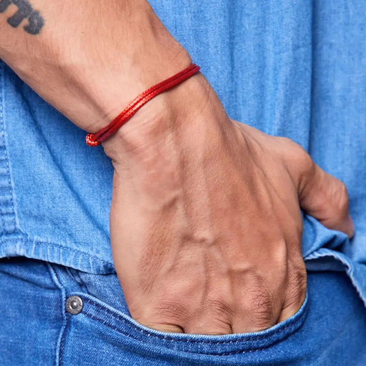 Close-up of a men wearing a red wax nylon bracelet 