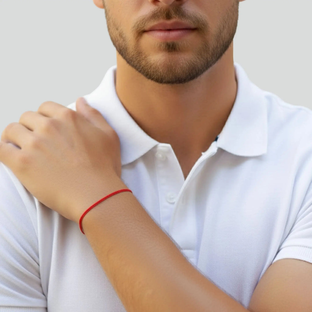 Person wearing a white polo shirt with a blurred background