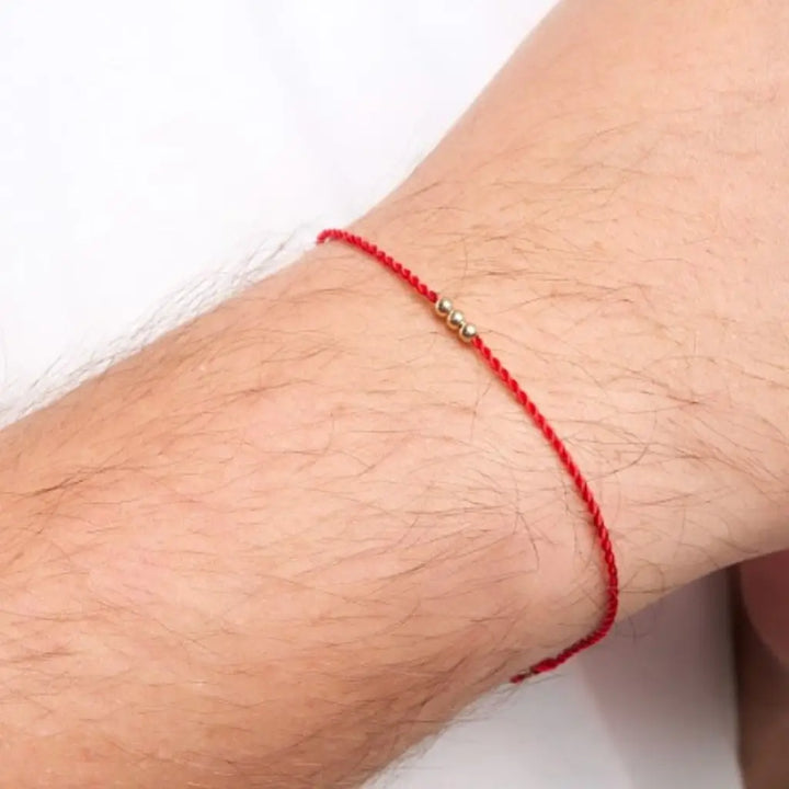 Man Wearing Solid 14K Gold Red String Bracelet Handmade by Luck Strings