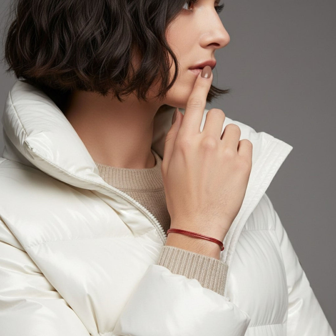 Woman wearing a white puffer jacket with a neutral background