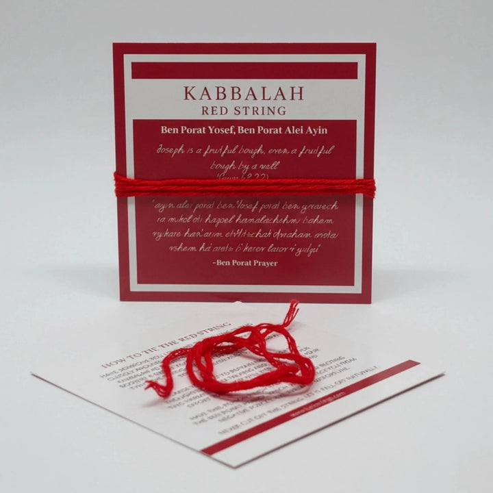 Kabbalah red string with a card on a white background