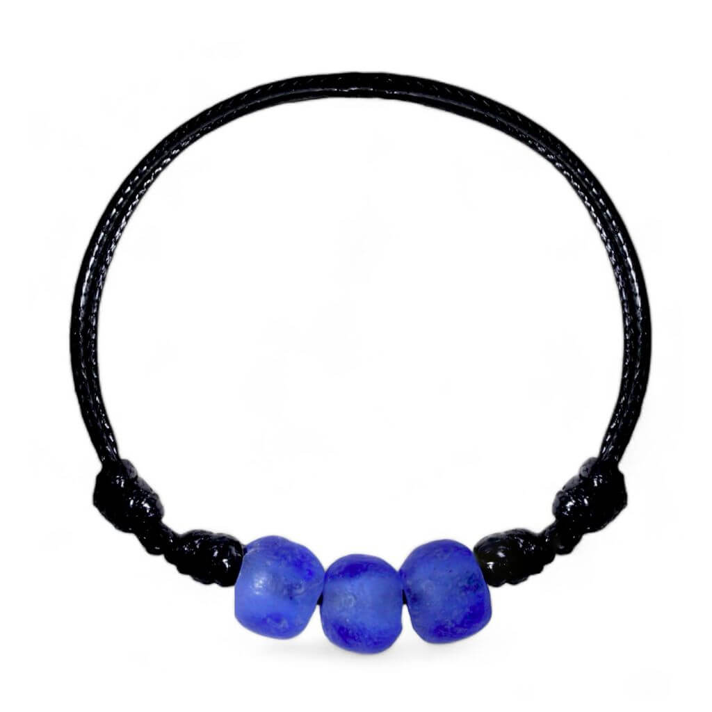 An adjustable black cord bracelet with three blue glass beads, made from recycled glass.