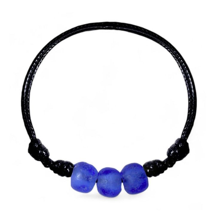 An adjustable black cord bracelet with three blue glass beads, made from recycled glass.