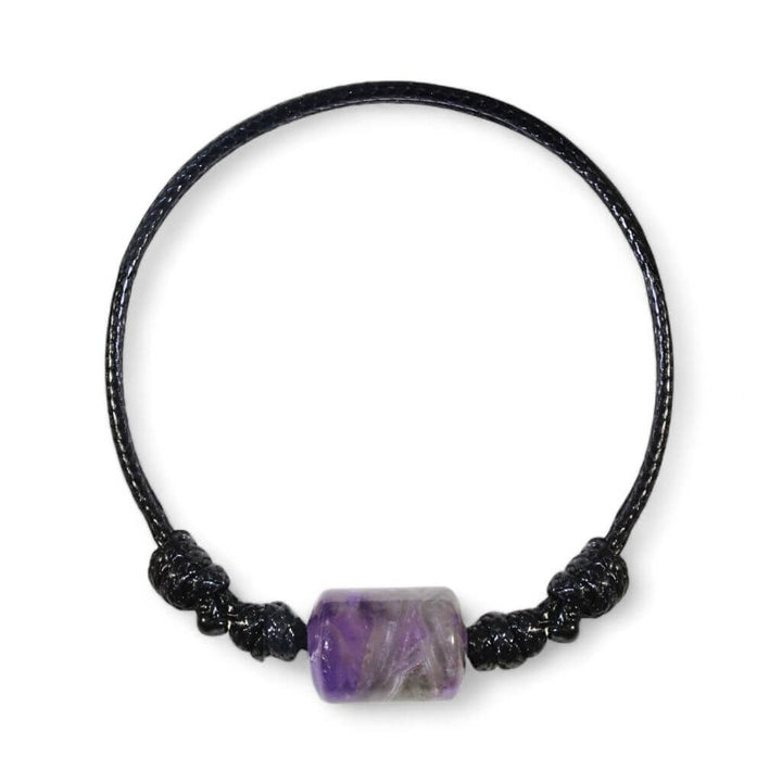 Smooth amethyst cylinder bead bracelet on black waxed nylon cord.