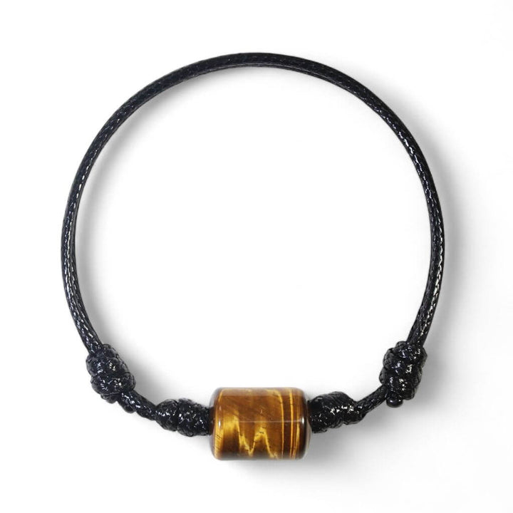 Smooth tiger’s eye cylinder bead bracelet on black waxed nylon cord.