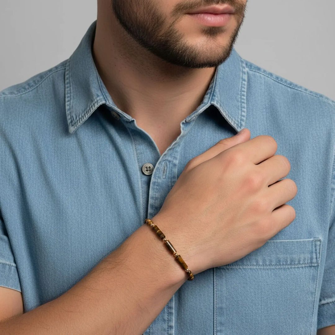 Man wearing a light blue denim shirt with a blurred background